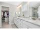 Bright bathroom featuring double sinks, granite counters and a walk-in closet at 5009 Megara, Raleigh, NC 27603