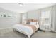 A bright bedroom featuring neutral walls, carpeted floors, three windows, and a bed with plush pillows at 5009 Megara, Raleigh, NC 27603