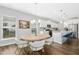 Open-concept dining area adjacent to a modern kitchen, featuring stylish furnishings and natural light at 5009 Megara, Raleigh, NC 27603