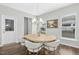 Bright dining room featuring a modern chandelier, seating for six, and views of the outside at 5009 Megara, Raleigh, NC 27603