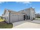 Rear exterior showing a two car garage, screened in porch and concrete driveway at 5009 Megara, Raleigh, NC 27603
