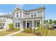 Beautiful home featuring gray siding, a cozy front porch with seating, and well-maintained landscaping at 5009 Megara, Raleigh, NC 27603
