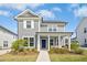 Charming two-story home featuring gray siding, a cozy front porch, and well-manicured landscaping at 5009 Megara, Raleigh, NC 27603