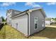 Home exterior featuring gray siding and well-maintained landscaping in the fenced backyard at 5009 Megara, Raleigh, NC 27603
