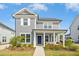 Charming two-story home with a well-manicured lawn and inviting porch with blue door at 5009 Megara, Raleigh, NC 27603
