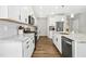 A well-equipped kitchen features white cabinets, granite countertops, stainless steel appliances, and modern finishes at 5009 Megara, Raleigh, NC 27603