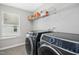 Well-organized laundry room features modern appliances and shelving for convenient storage solutions at 5009 Megara, Raleigh, NC 27603