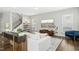 Stylish living room with modern furnishings, a large TV, and an open staircase, perfect for entertaining at 5009 Megara, Raleigh, NC 27603