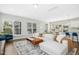 Spacious open concept living room featuring a white sectional, natural light, and modern decor at 5009 Megara, Raleigh, NC 27603