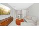 Bright living room with sectional sofa, orange ottoman, and mounted TV at 5009 Megara, Raleigh, NC 27603