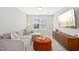 Cozy living room with plush sectional sofa, orange ottoman, and mounted TV at 5009 Megara, Raleigh, NC 27603