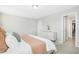 A bedroom with carpeted floors, white trim, and a view of a dresser and an open door to a walk-in closet at 5009 Megara, Raleigh, NC 27603