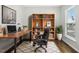 Bright home office with a large wooden desk, bookshelf, and comfortable desk chair at 5009 Megara, Raleigh, NC 27603