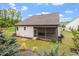 Backyard view featuring screen porch, well-maintained lawn, and lush landscaping at 52 Brunello Ct, Clayton, NC 27527