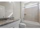 Bathroom features a granite vanity, a tiled shower, and ample natural light at 52 Brunello Ct, Clayton, NC 27527