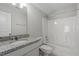 Bright bathroom featuring granite-topped vanity and shower-tub combo at 52 Brunello Ct, Clayton, NC 27527