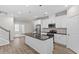Bright kitchen features a large island with a granite countertop, stainless steel appliances, and white cabinets at 52 Brunello Ct, Clayton, NC 27527