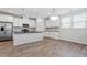 Modern kitchen with white cabinets, sleek countertops, stainless steel appliances, and a central island for food preparation at 52 Brunello Ct, Clayton, NC 27527