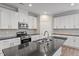 Spacious kitchen featuring stainless steel appliances, granite counters, and plentiful white cabinets at 52 Brunello Ct, Clayton, NC 27527