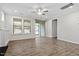 Open living room with large windows, a sliding glass door, and a ceiling fan offering both light and natural airflow at 52 Brunello Ct, Clayton, NC 27527