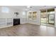 Bright living room featuring a fireplace, built-in shelves, large windows, and a sliding door to the outdoor space at 52 Brunello Ct, Clayton, NC 27527