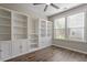 Home office with hardwood floors, built-in bookshelves, and a large window for natural light at 52 Brunello Ct, Clayton, NC 27527