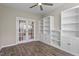 Bright home office featuring hardwood floors, a built-in bookcase, and glass paneled doors at 52 Brunello Ct, Clayton, NC 27527