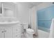 Bathroom vanity and shower with blue tile and a white shower curtain at 526 Colony Woods Dr, Chapel Hill, NC 27517