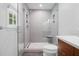 Bathroom featuring a glass shower with gray tiled walls, and a built-in shower seat at 526 Colony Woods Dr, Chapel Hill, NC 27517