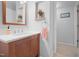Bright bathroom featuring a wood vanity with a light countertop, a decorative mirror, and neutral wall paint at 526 Colony Woods Dr, Chapel Hill, NC 27517