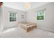 Neutral Bedroom with multiple windows and a platform bed on neutral carpet at 526 Colony Woods Dr, Chapel Hill, NC 27517