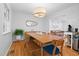 Dining area with seating for six, light wood floors, and access to the living room at 526 Colony Woods Dr, Chapel Hill, NC 27517