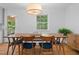 Dining area featuring a wood table with seating for six, a large window, and light wood floors at 526 Colony Woods Dr, Chapel Hill, NC 27517