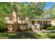 Charming two-story home featuring a brick chimney, shuttered windows, and a welcoming front entrance with stairs at 526 Colony Woods Dr, Chapel Hill, NC 27517