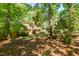 Charming two-story home with a brick chimney and well-maintained lawn surrounded by lush trees at 526 Colony Woods Dr, Chapel Hill, NC 27517