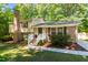 Traditional home showcases brick and siding, complemented by a welcoming front porch and well-manicured landscaping at 526 Colony Woods Dr, Chapel Hill, NC 27517