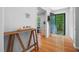 Bright foyer with hardwood floors, a decorative table, and a view of the outdoors through the open doorway at 526 Colony Woods Dr, Chapel Hill, NC 27517