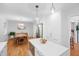 Bright, open kitchen with modern stainless steel appliances, hardwood floors, and a stylish dining area at 526 Colony Woods Dr, Chapel Hill, NC 27517