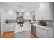 Bright kitchen featuring white cabinetry, gray backsplash, and modern fixtures, creating a stylish cooking space at 526 Colony Woods Dr, Chapel Hill, NC 27517