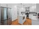 Modern kitchen with white cabinets, stainless steel appliances, and a functional island, ideal for culinary enthusiasts at 526 Colony Woods Dr, Chapel Hill, NC 27517