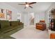 Living room featuring an olive green sofa, a fireplace, and access to the laundry room at 526 Colony Woods Dr, Chapel Hill, NC 27517