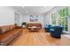 Spacious living room with hardwood floors, comfortable seating, and a large window for natural light at 526 Colony Woods Dr, Chapel Hill, NC 27517