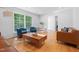Inviting living room featuring hardwood floors, stylish furniture, and a large window offering ample natural light at 526 Colony Woods Dr, Chapel Hill, NC 27517