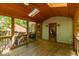 A cozy screened porch with wood floors and ceiling, skylights, and an open view of the backyard at 526 Colony Woods Dr, Chapel Hill, NC 27517