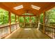 Open screened porch with wood flooring, skylights, ceiling fan, and natural light creating a bright and airy atmosphere at 526 Colony Woods Dr, Chapel Hill, NC 27517