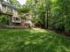 Landscaped backyard with mature trees, a lush lawn, and outdoor seating at 5317 Deep Valley, Raleigh, NC 27606