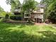 Spacious backyard featuring a patio area, lush green lawn, and mature trees at 5317 Deep Valley, Raleigh, NC 27606