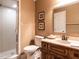 Cozy bathroom with glass door shower, vanity and neutral tones at 5317 Deep Valley, Raleigh, NC 27606