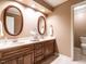 Bathroom features a double vanity with wood cabinets and ample lighting at 5317 Deep Valley, Raleigh, NC 27606