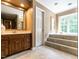 Elegant bathroom with vanity, soaking tub and tile floor at 5317 Deep Valley, Raleigh, NC 27606